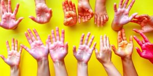 Playful children's hands and feet in bright colors.